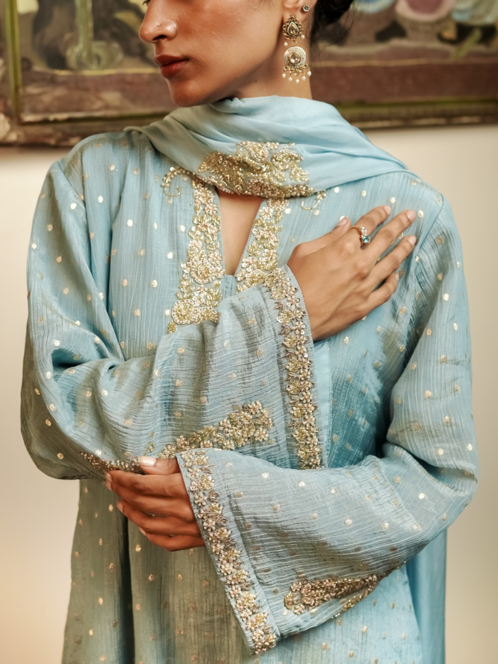 Powder blue crinkled silk kurta set with woven gold dots and zardosi embroidered neckline and sleeve